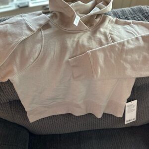 Brand new cropped Lululemon hoodie. Cream with gold sparkles in the material